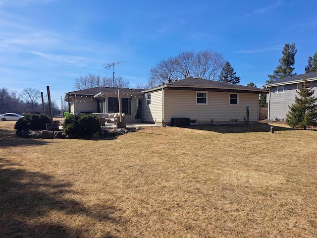 back of house with a patio, an attached garage, a lawn, and central AC