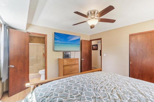 bedroom featuring ensuite bath, visible vents, a closet, and ceiling fan