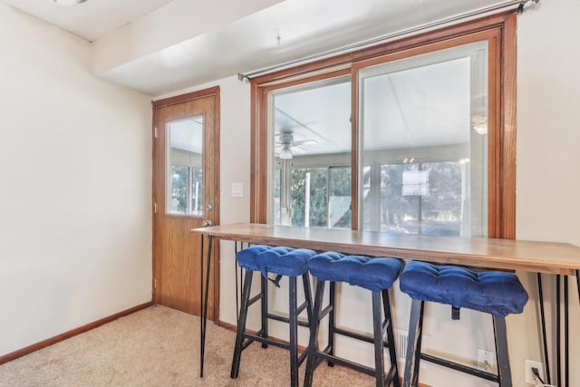 dining area with baseboards and carpet flooring