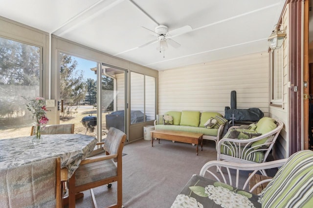 sunroom / solarium with a ceiling fan