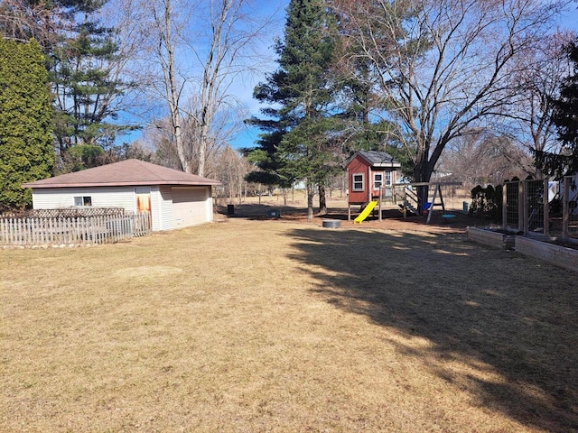 view of yard with an outbuilding, fence, and a detached garage