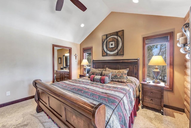 bedroom featuring baseboards, ceiling fan, vaulted ceiling, light colored carpet, and connected bathroom