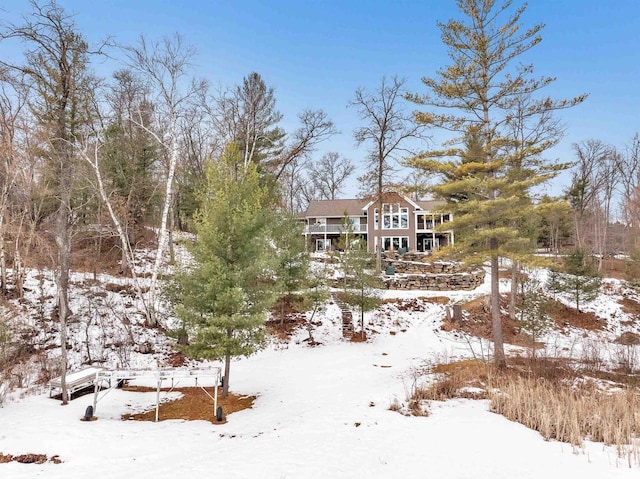 view of snow covered back of property