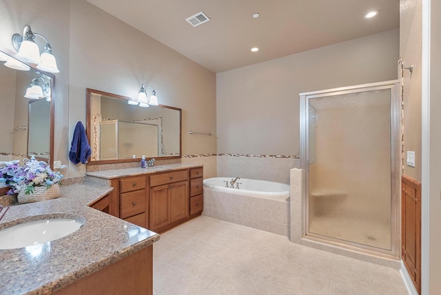 bathroom featuring visible vents, two vanities, a sink, a shower stall, and a bath