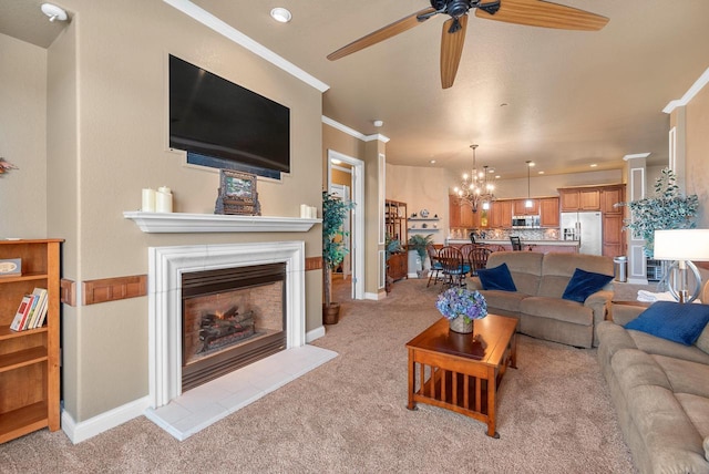 living area with baseboards, light carpet, crown molding, and ceiling fan with notable chandelier