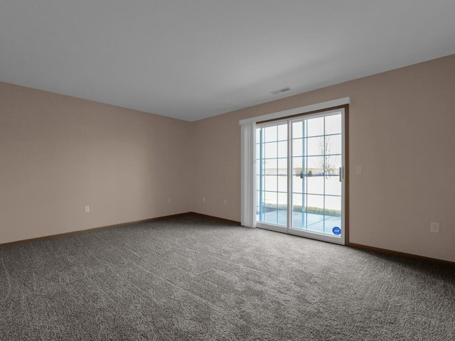 carpeted empty room featuring visible vents and baseboards