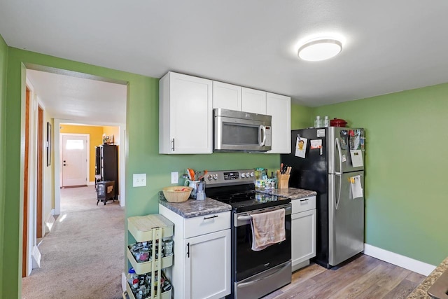 kitchen featuring white cabinetry, baseboards, and appliances with stainless steel finishes