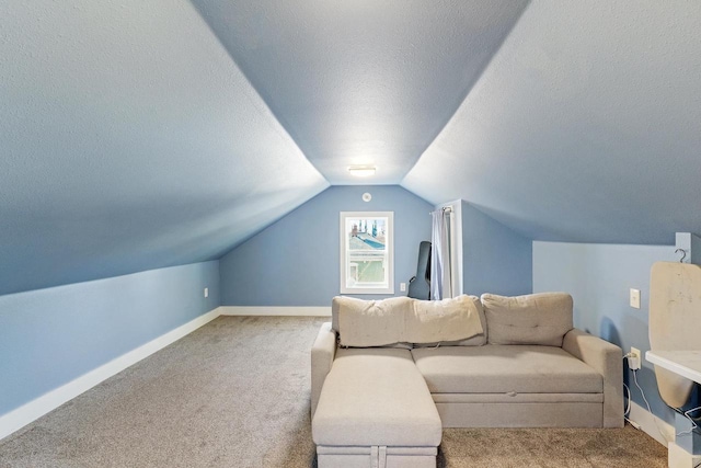 living room with baseboards, a textured ceiling, lofted ceiling, and carpet flooring