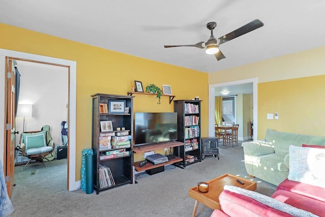 living area with carpet and ceiling fan