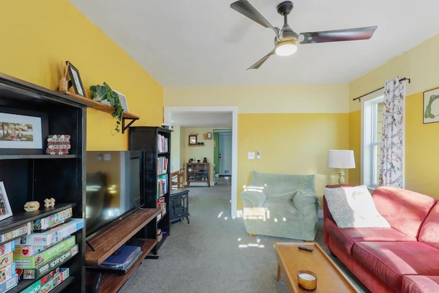 carpeted living area featuring ceiling fan