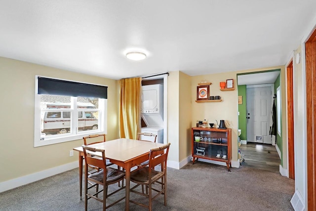 dining space with carpet, stacked washer and clothes dryer, and baseboards