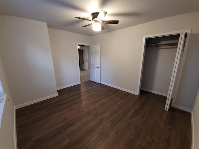 unfurnished bedroom with a closet, baseboards, ceiling fan, and dark wood-style flooring