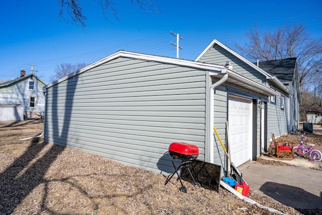 view of property exterior with central air condition unit and an attached garage