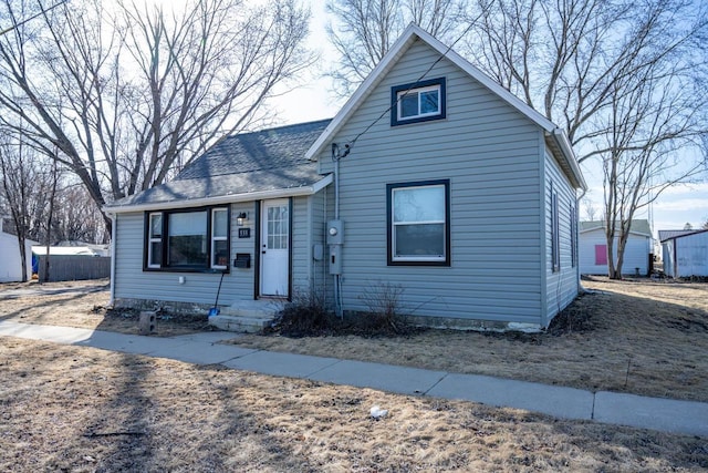 bungalow-style house with a shingled roof