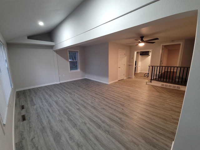 interior space featuring baseboards, a ceiling fan, lofted ceiling, and wood finished floors