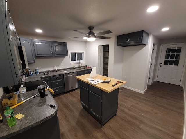 kitchen with dark wood-type flooring, a center island, recessed lighting, wooden counters, and dishwasher