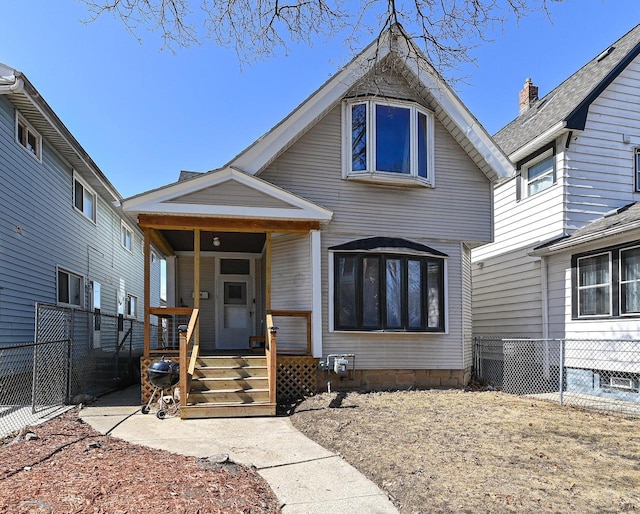 view of front of home with a porch and fence