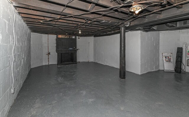 unfinished basement with concrete block wall