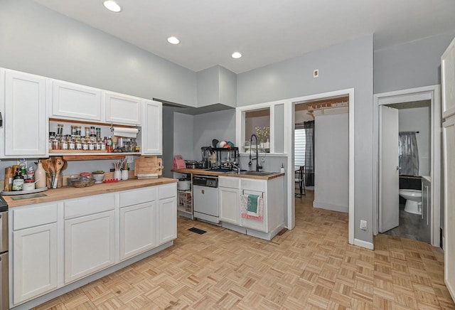 kitchen featuring a sink, recessed lighting, white cabinets, butcher block counters, and white dishwasher