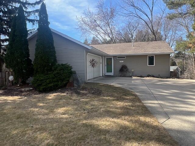 view of front facade with concrete driveway and a garage