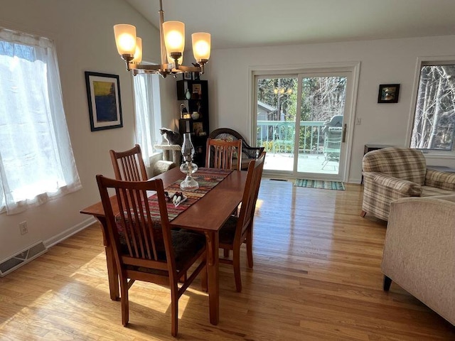 dining area featuring a wealth of natural light, visible vents, and light wood-style floors