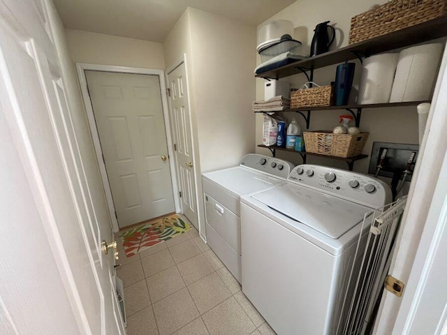 washroom featuring laundry area, washing machine and dryer, and light floors