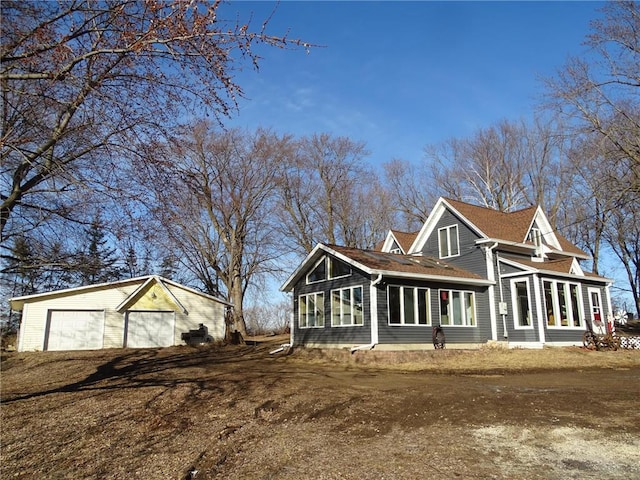 exterior space featuring a garage and an outdoor structure