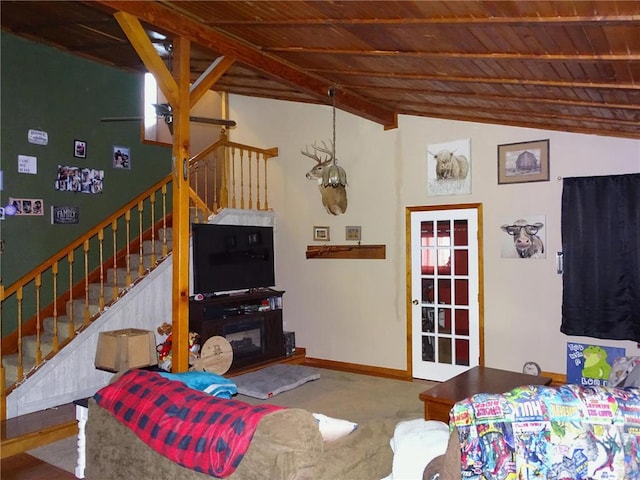 living area featuring ceiling fan, baseboards, stairway, wood ceiling, and lofted ceiling with beams