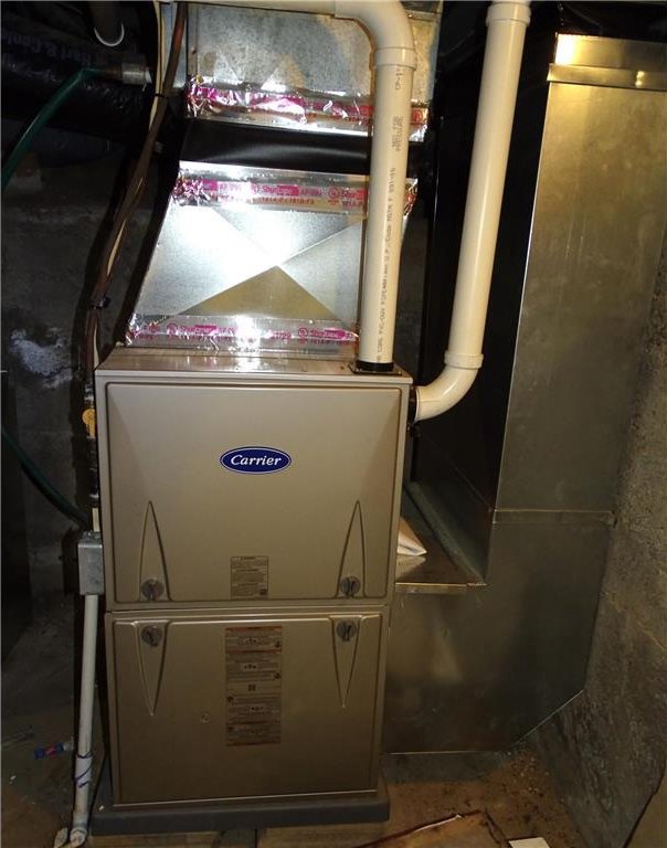 utility room featuring heating unit