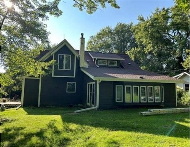 rear view of property with a lawn