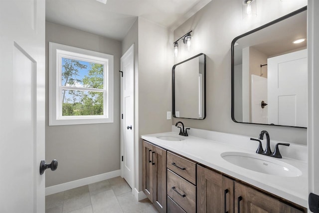 2570 Meyer Way, De Pere, WI 54115 - bathroom with double vanity, baseboards, and tile patterned floors