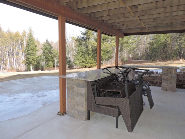 view of patio featuring a wooded view