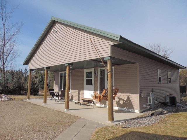 back of house featuring cooling unit and a patio area