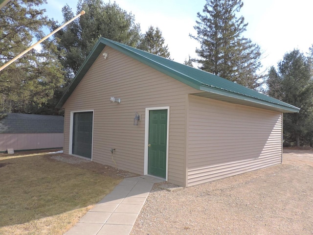 back of property with a yard and an outdoor structure