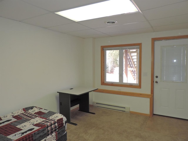 entrance foyer featuring visible vents, baseboards, a drop ceiling, light colored carpet, and baseboard heating