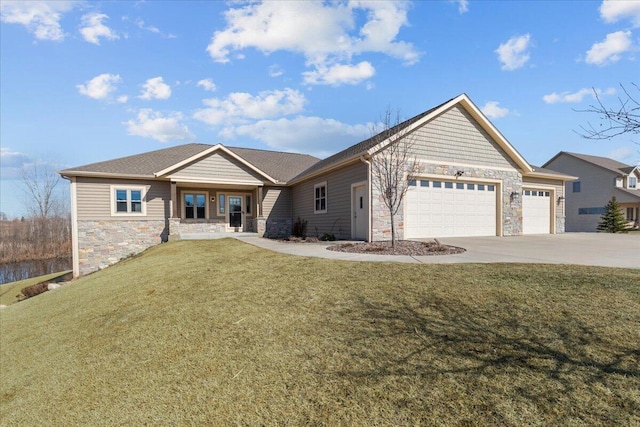 view of front of property with a garage, stone siding, driveway, and a front yard