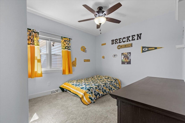 carpeted bedroom featuring visible vents, baseboards, and a ceiling fan