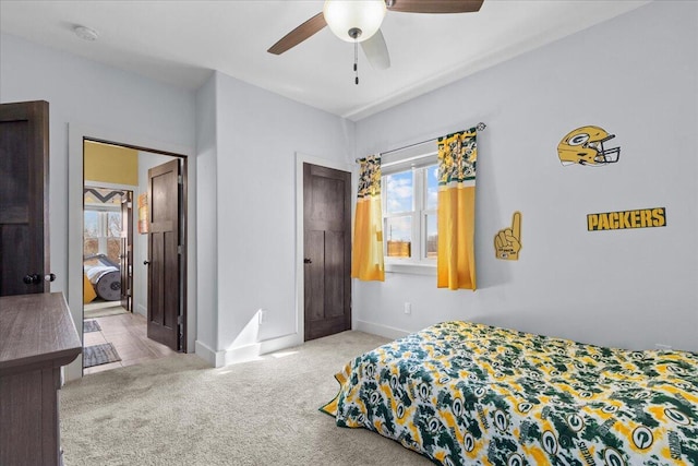 bedroom with carpet flooring, multiple windows, a ceiling fan, and baseboards