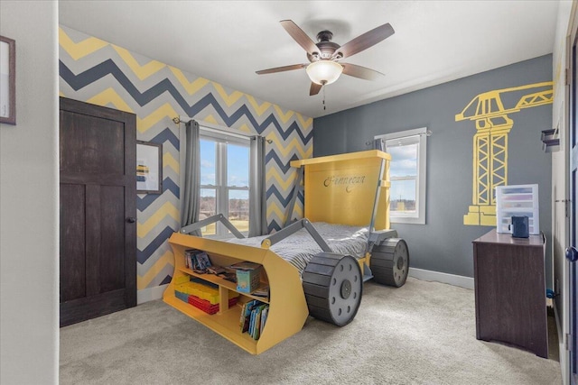 carpeted bedroom with baseboards, ceiling fan, and wallpapered walls