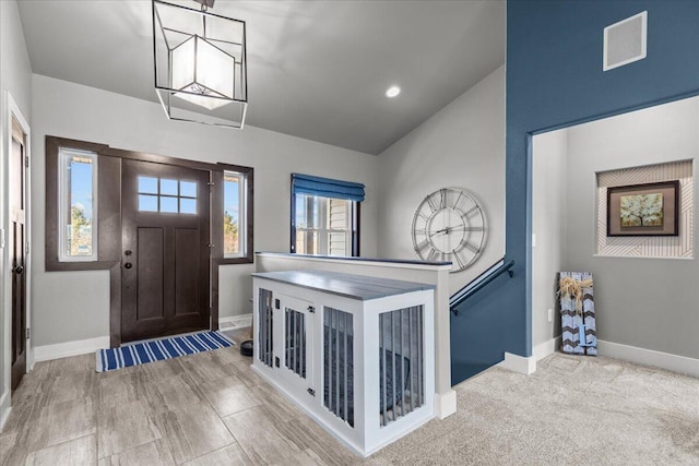 entrance foyer with recessed lighting, visible vents, baseboards, and lofted ceiling