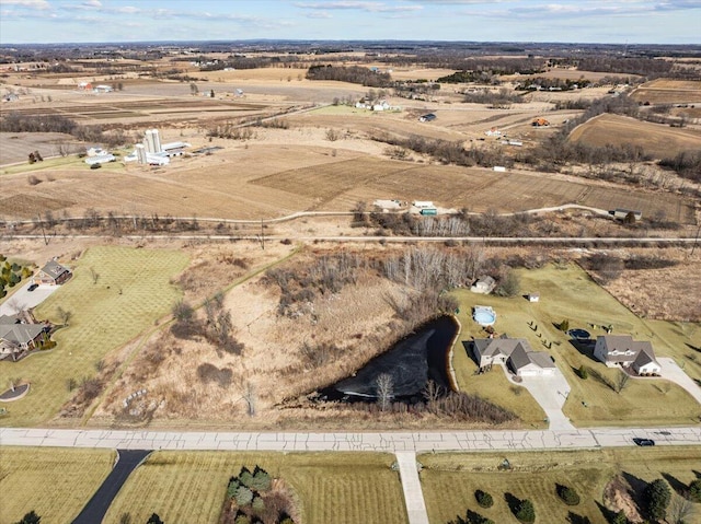 birds eye view of property with a rural view