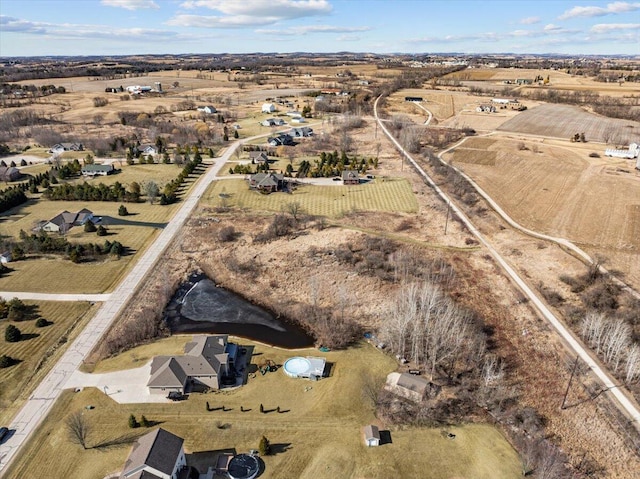 birds eye view of property with a rural view