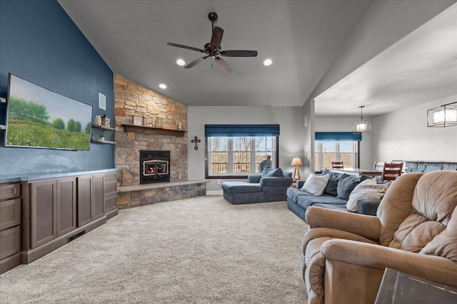 carpeted living area with recessed lighting, a stone fireplace, ceiling fan, and vaulted ceiling