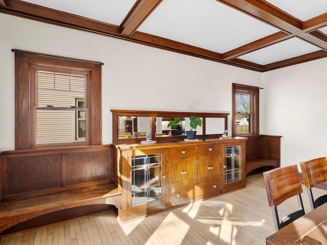 bar with beam ceiling, light wood-style flooring, coffered ceiling, and crown molding