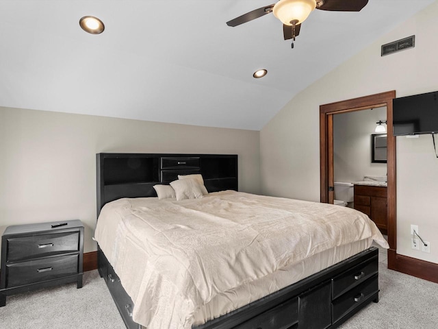 bedroom with visible vents, light colored carpet, baseboards, and vaulted ceiling