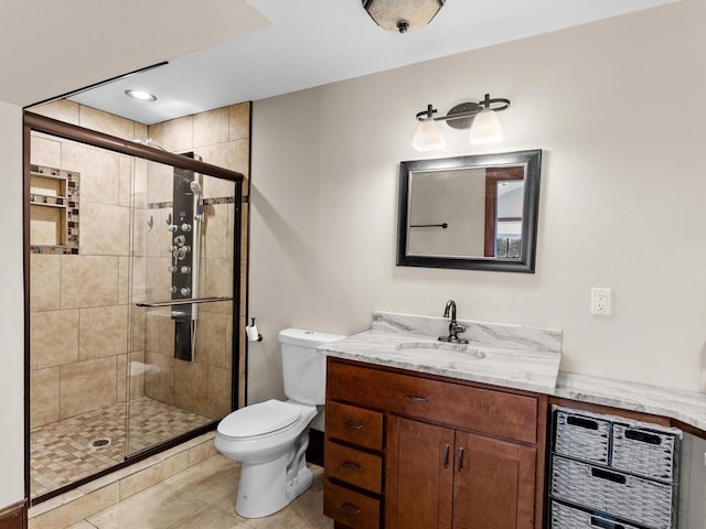 bathroom with toilet, a stall shower, and vanity