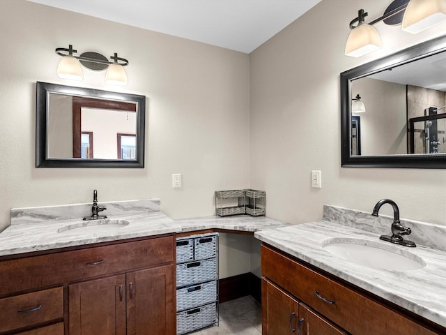 full bathroom with a sink, two vanities, and tile patterned flooring