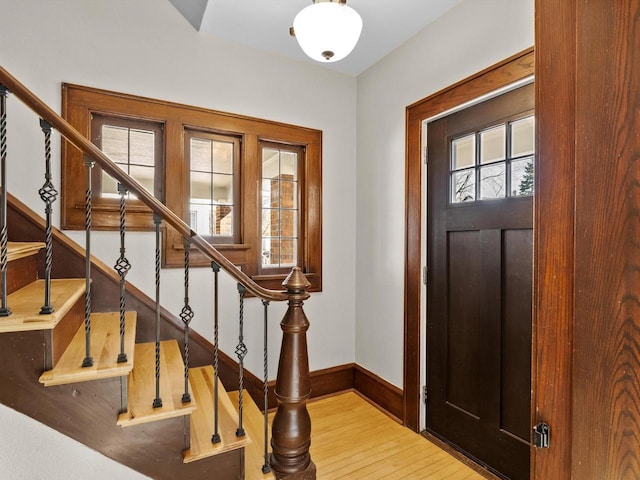 foyer featuring stairway, baseboards, and hardwood / wood-style flooring