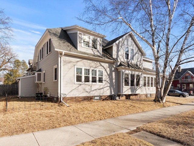 view of front of home featuring a shingled roof and fence