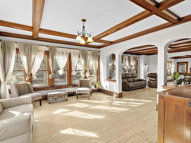 living room with arched walkways, light wood-style flooring, and coffered ceiling